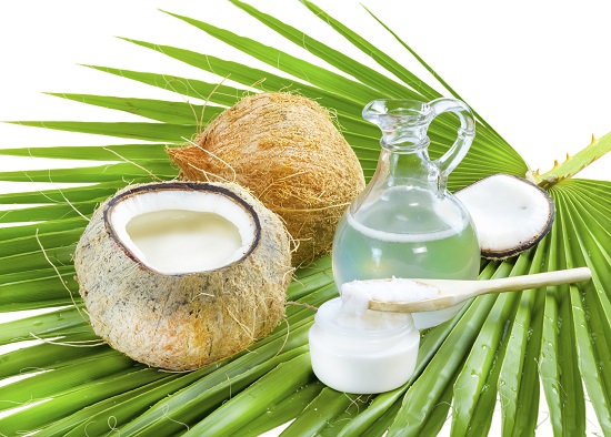 Liquid and solid coconut oil on palm leaf .